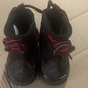 Toddler Nike Air Jordan Black and Red Sneakers.
